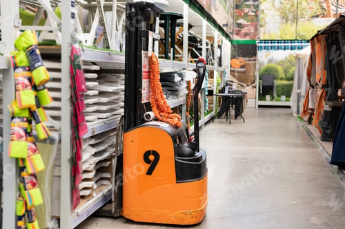 Preview: Hand pallet truck with the rice bag and plastic pallets with goods in the wholesale market. Unloadin