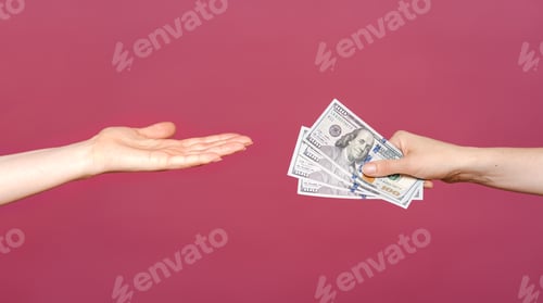 Preview: Woman reached hand for money isolated on pink