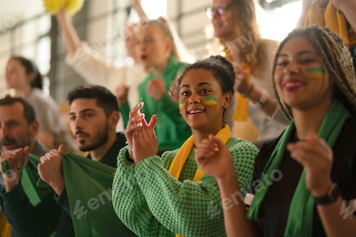 Preview: Brazilian young sisters football fans supporting their team at stadium.