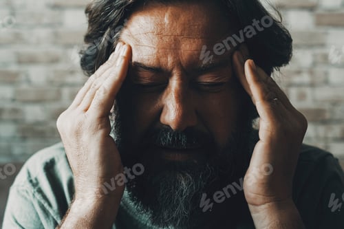 Preview: Close up portrait of man touching his head and temples for headache or problems to solve.