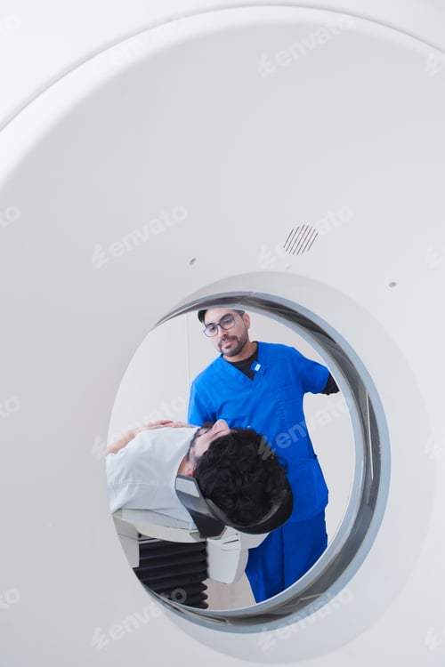 Preview: Healthcare professional preparing a patient for a CT scan
