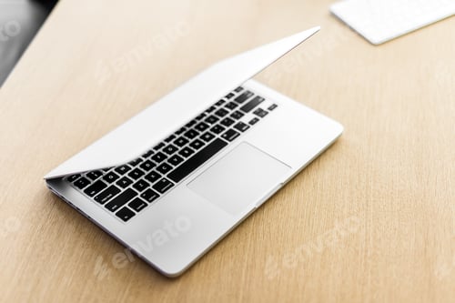 Preview: Laptop on wooden table and blurred background