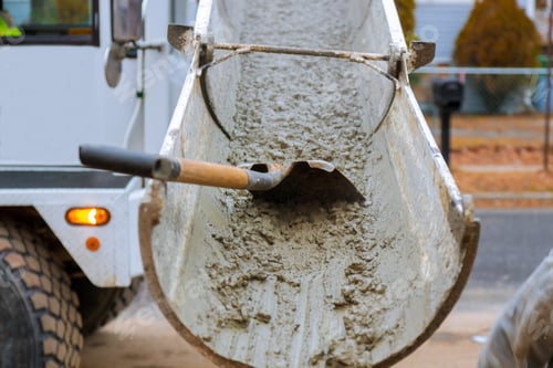 Preview: Concrete truck with pouring cement during to residential street selective focus