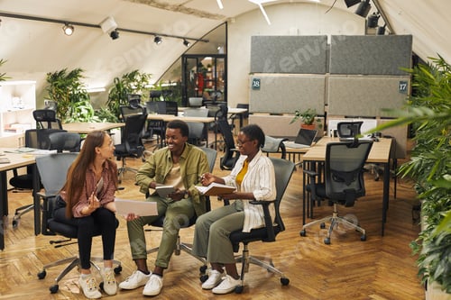 Preview: Team Collaborating on Project in Eco Friendly Office