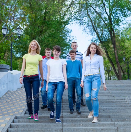 Preview: Group of smiling teenagers walking outdoors