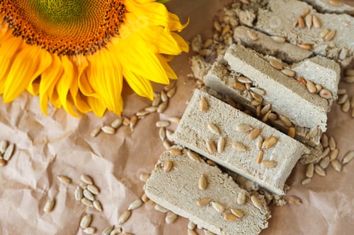 Preview: Halva cut into pieces with sunflower seeds top view. Country style.