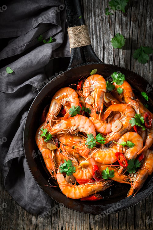 Preview: Tasty shrimps on pan with garlic, coriander and peppers