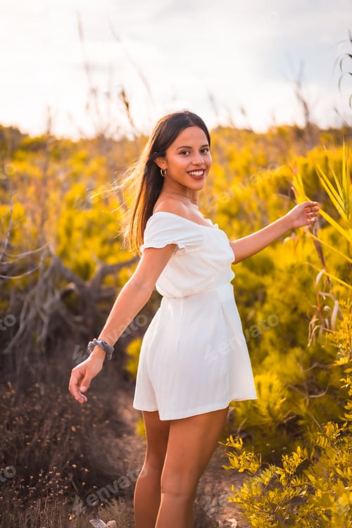 Preview: Lifestyle of a young brunette Caucasian enjoying the beach vacation in a white dress
