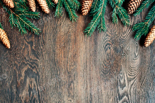 Preview: Natural Christmas background, brown wooden texture decorated with fir branches and cones