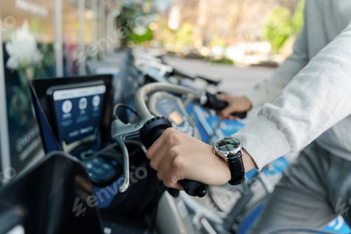 Preview: Selective focus, closeup of man holding handlebars of rental bicycle outdoors