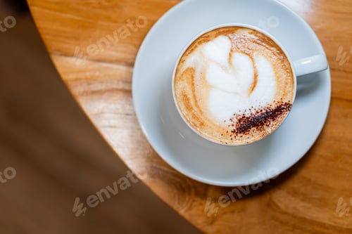 Preview: Cappuccino with Latte Art on Wooden Table