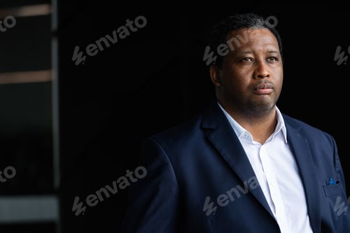 Preview: Portrait of handsome black man wearing suit and thinking