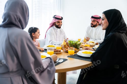 Preview: Happy arab family wearing saudi arabia clothing at home
