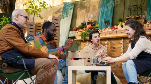 Preview: Happy group of people enjoying food tasting at local farmers market