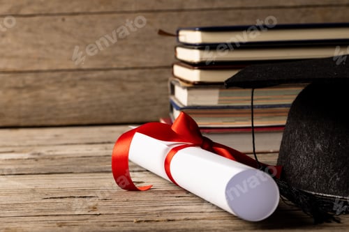 Preview: Image of stack of books and diploma on wooden surface