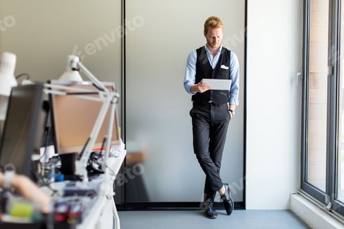 Preview: Man with tablet in office