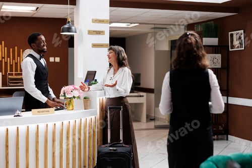 Preview: Male concierge speaks with hotel guest
