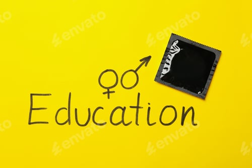 Preview: Text Education and condom on yellow background