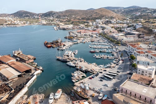Preview: Syros island, Greece, aerial drone view. Saiboats moored at Ermoupolis port dock, yachts marina.