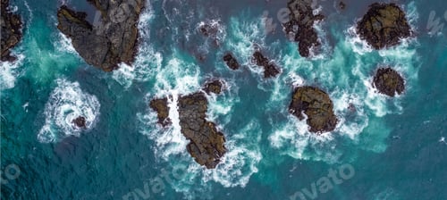 Preview: Aerial view of ocean waves crashing against rocky coastline