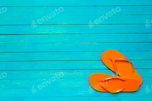 Preview: Vibrant Orange Flip Flops on a Turquoise Wooden Surface