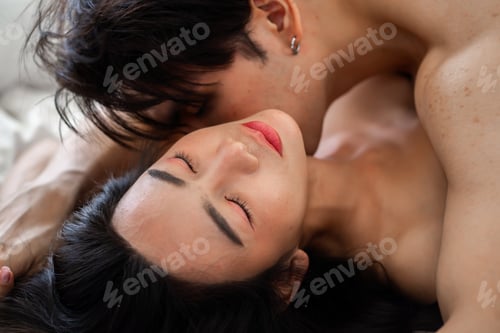 Preview: Asian couple, man and woman making love on the bed in the bedroom.