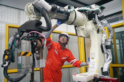 Preview: Robotics control engineers setting programming of control panel for industrial robot arm