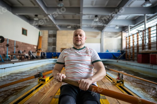 Man Rowing in Indoor Training Facility