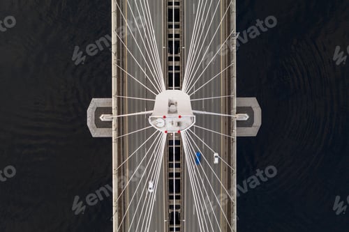 Preview: Aerial shot of a cable-stayed bridge with cars driving and black waters ofon both sides