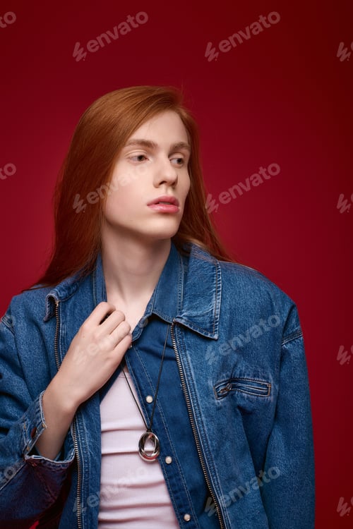 Preview: Prideful person showcasing unique style with confidence against vibrant red backdrop
