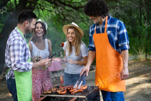 Preview: Group of friends having a barbecue party in nature