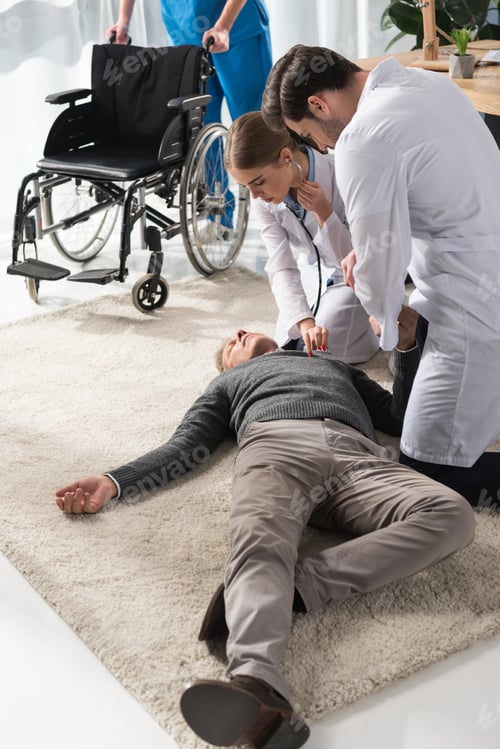 Preview: female doctor checking unconscious man palpitation with stethoscope