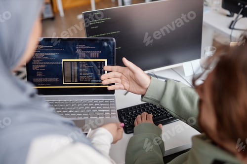 Preview: Two Colleagues Reviewing Code in IT Development Office