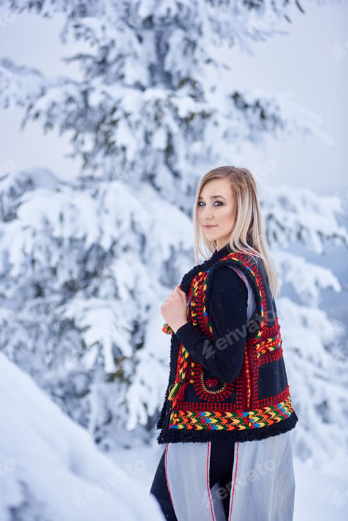 Preview: Young attractive woman in white fur coat. Traditional women's attire of western part of Ukraine.
