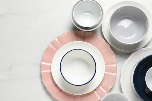 Preview: Beautiful ceramic dishware on white marble table, flat lay. Space for text