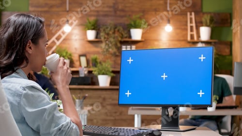 Preview: Businesswoman looking at mock up green screen chroma key computer with isolated display