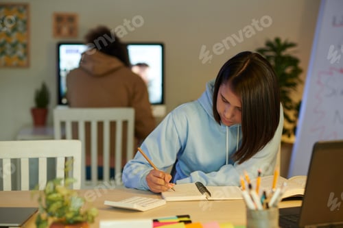 Preview: Schoolgirl Writing down Formulas