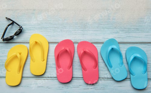 Preview: Colorful flip flops and sunglasses resting on beach boardwalk, embracing summer vibes