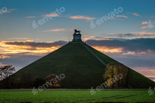 Preview: Lion's Mound on a high grassy hill in Belgium under the breathtaking sky