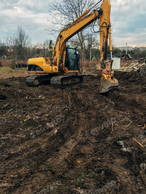 Preview: Bulldozer clearing land from old trees, roots and branches with dirt and trash