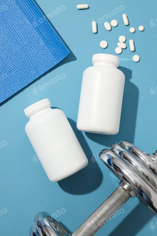 Preview: White plastic jars with pills and sport equipment on blue background, top view