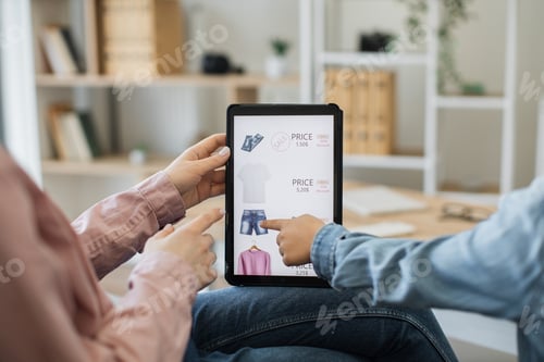 Preview: Close up of tablet with clothes webstore on screen