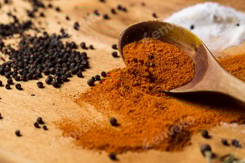 Preview: Spoon and heap of spices on the table