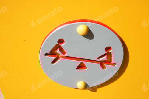 Preview: Red seesaw sign on a yellow surface
