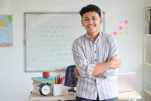 Preview: Confident Asian male teacher at elementary school class