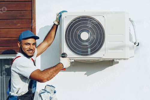 Preview: Repairman in uniform installing the outside unit of air conditioner
