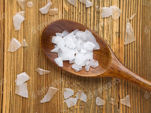 Preview: Flatlay of magnesium flakes on table and spoon.