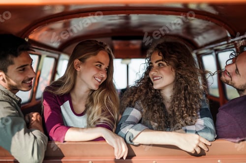 Preview: A group of young friends on a roadtrip through countryside, sitting in a car.