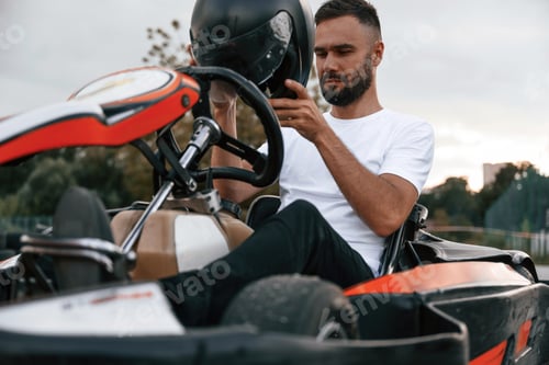 Preview: Man Preparing for Go Karting on Cloudy Day