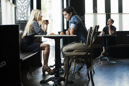 Preview: Couple having coffee in cafe